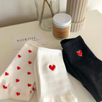 Socks with red heart embroidery.