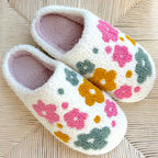White slippers with floral pattern.